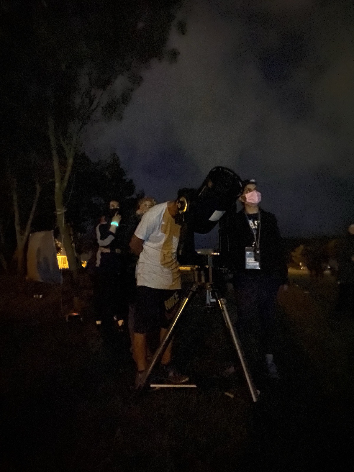 Gece kamp alanında teleskopla gökyüzü gözlemi yapan katılımcılar